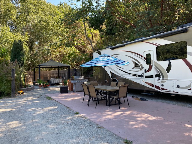 Our best sites! Amazing amount of space for your RV and vehicle or second RV! Includes paved patio, propane grill, private gazebo, and a fire pit.